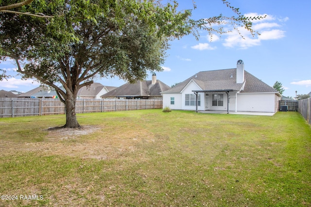 view of yard featuring central AC and a patio