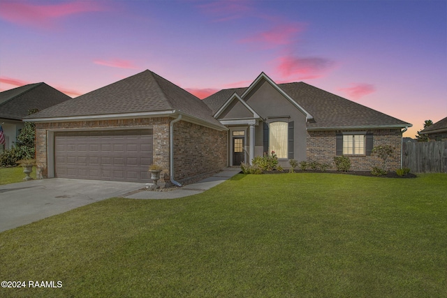 view of front of property featuring a lawn and a garage