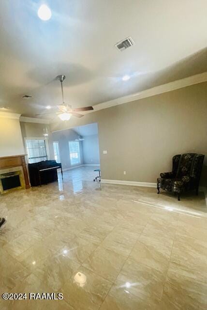 unfurnished living room featuring ornamental molding and ceiling fan