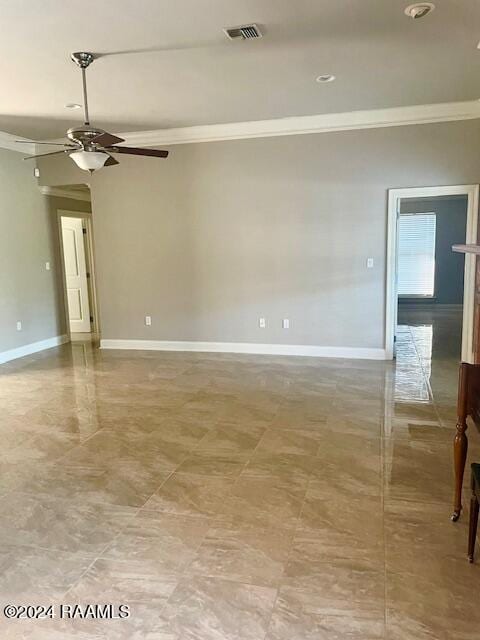 empty room with ornamental molding and ceiling fan