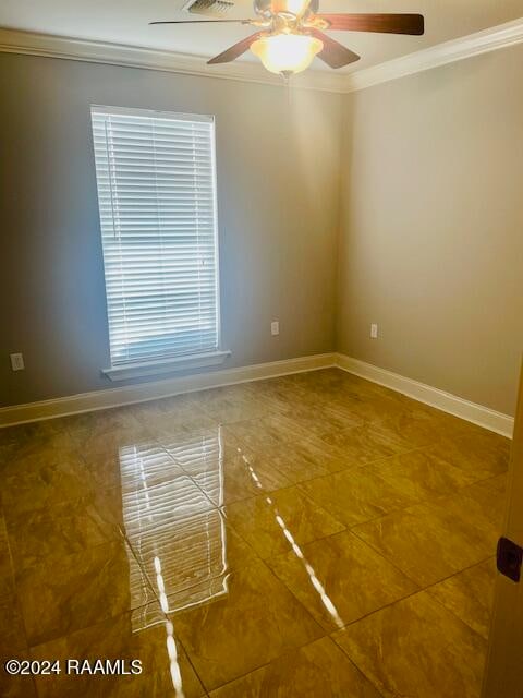 empty room featuring crown molding and ceiling fan