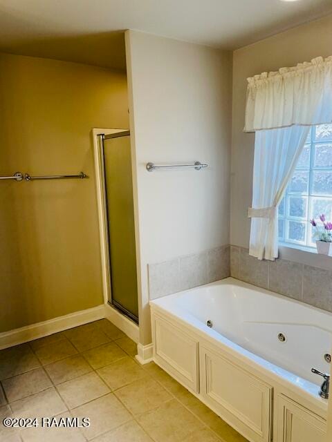 bathroom featuring independent shower and bath and tile patterned flooring