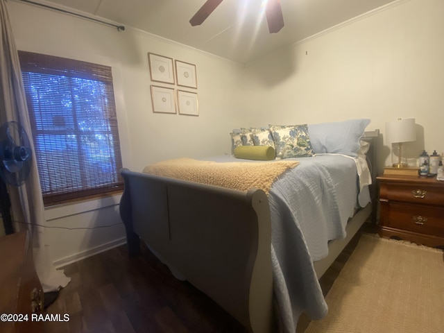 bedroom featuring ceiling fan, ornamental molding, and hardwood / wood-style floors