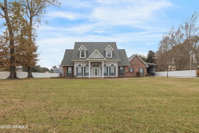 cape cod house featuring a front yard