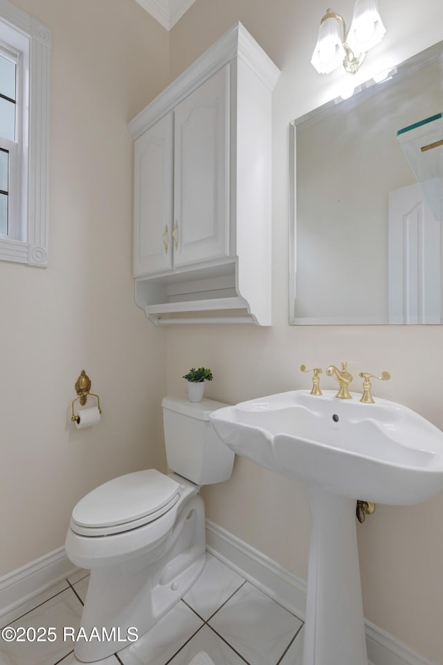 bathroom with sink, toilet, and tile patterned flooring