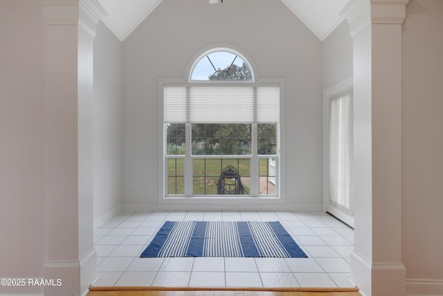 spare room featuring light tile patterned floors and high vaulted ceiling