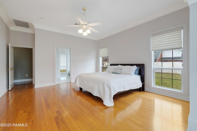 bedroom featuring ceiling fan, ornamental molding, and light hardwood / wood-style floors