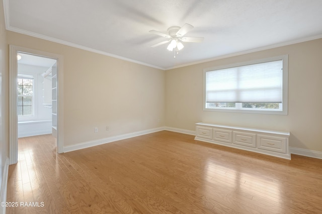 empty room featuring ceiling fan, ornamental molding, and light hardwood / wood-style flooring