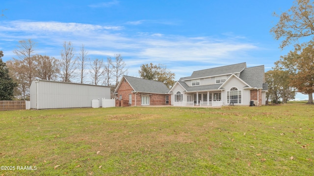 rear view of property featuring a yard