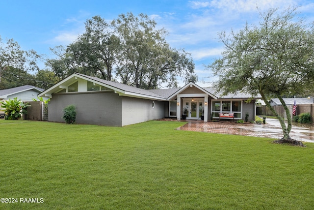 rear view of house with a lawn