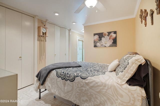 bedroom with ornamental molding, multiple closets, ceiling fan, and light tile patterned floors