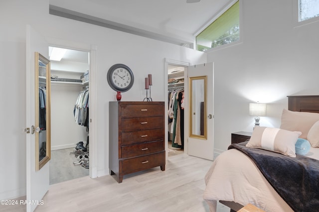 bedroom with light hardwood / wood-style flooring and lofted ceiling