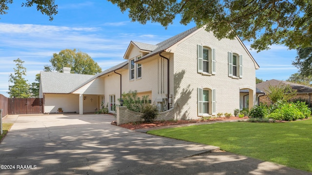 402 Old Settlement Rd, Lafayette, LA 70508 - traditional home with driveway, brick siding, a chimney, and a gate