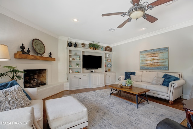 living room with crown molding, hardwood / wood-style flooring, and ceiling fan