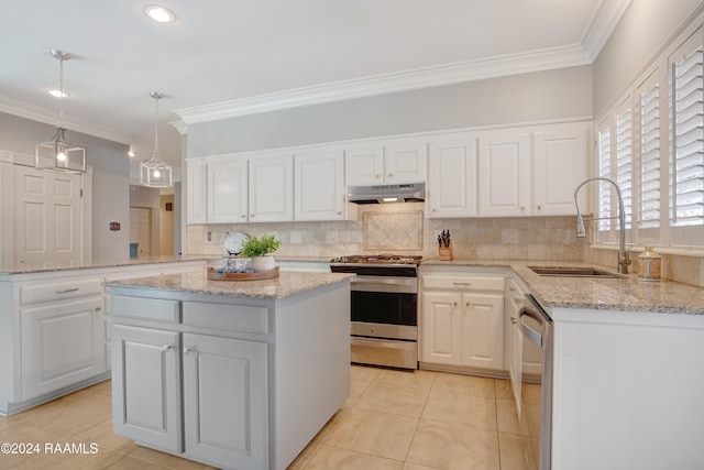 kitchen with sink, white cabinetry, stainless steel appliances, and a kitchen island