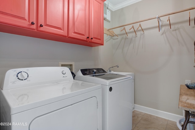 washroom with cabinets, light tile patterned floors, washing machine and dryer, crown molding, and sink