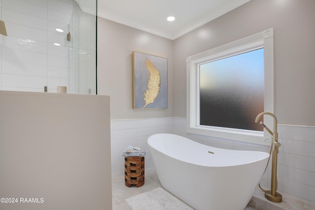 402 Old Settlement Rd, Lafayette, LA 70508 - full bathroom featuring tile walls, a freestanding tub, walk in shower, wainscoting, and crown molding