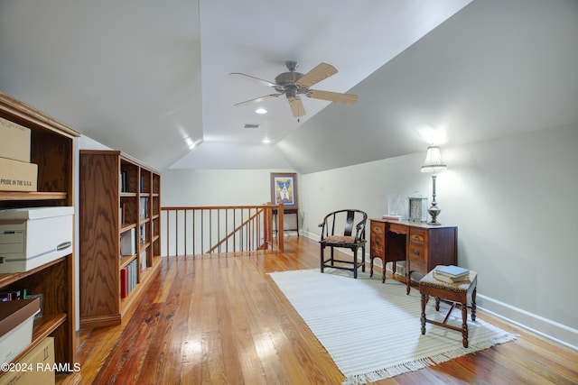 sitting room with lofted ceiling, hardwood / wood-style floors, and ceiling fan