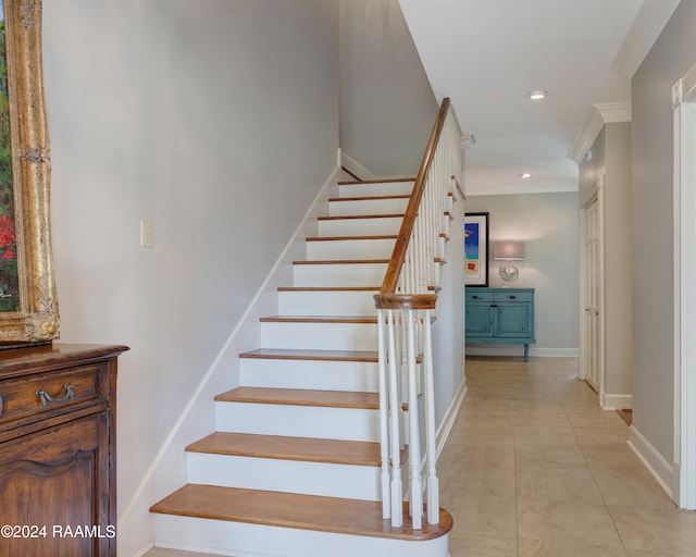 stairway featuring ornamental molding and tile patterned flooring