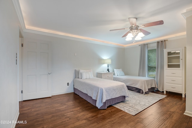 bedroom with crown molding, dark hardwood / wood-style floors, and ceiling fan