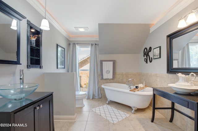 bathroom featuring tile patterned floors, toilet, ornamental molding, vanity, and a bath