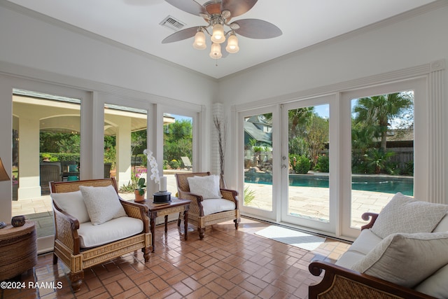 sunroom featuring ceiling fan