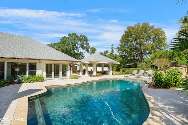 view of pool featuring french doors and a patio area