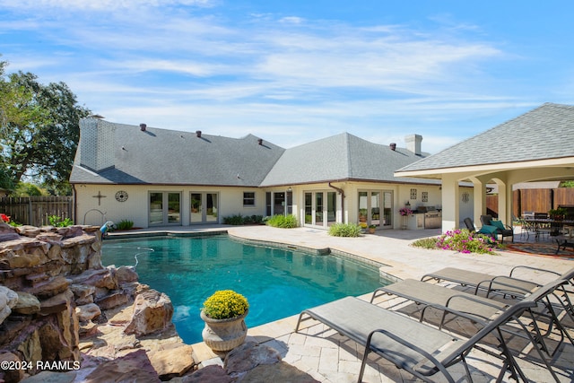 view of pool featuring french doors and a patio