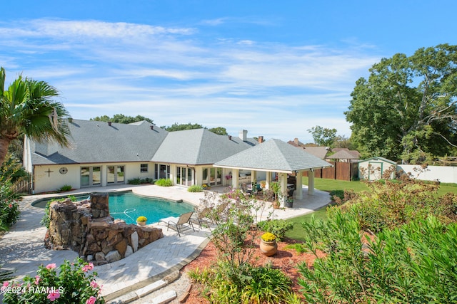 view of pool featuring a patio area and a storage unit