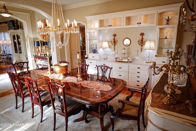 dining room featuring crown molding and light hardwood / wood-style flooring