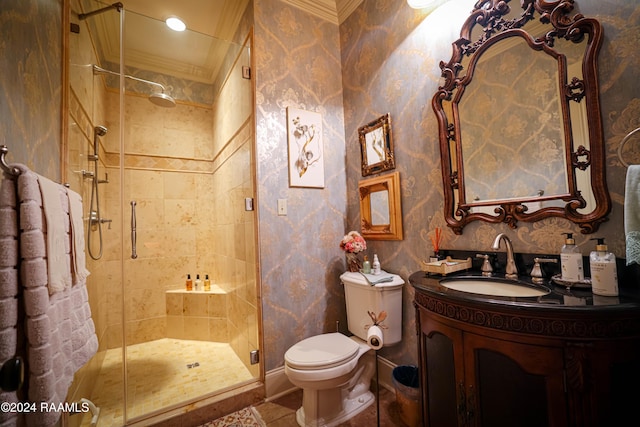 bathroom featuring a shower with door, vanity, crown molding, and toilet