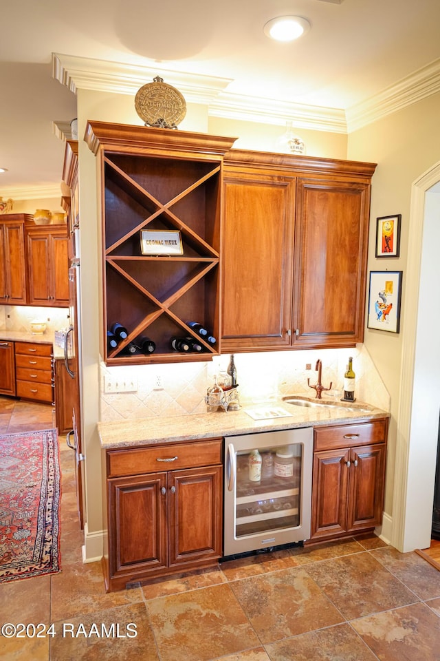 bar with decorative backsplash, ornamental molding, sink, and beverage cooler