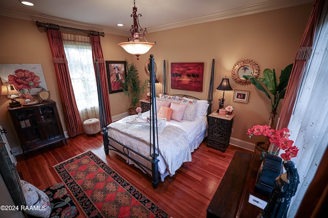 bedroom with crown molding and hardwood / wood-style flooring