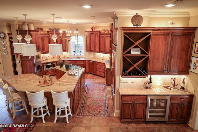 kitchen with a breakfast bar area, crown molding, decorative light fixtures, beverage cooler, and light stone counters