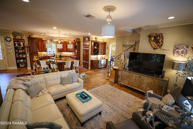 tiled living room with a notable chandelier and ornamental molding