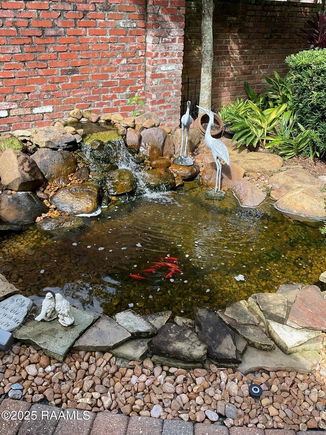 303 Sawgrass Ln, Broussard, LA 70518 - exterior view of a garden pond and brick siding