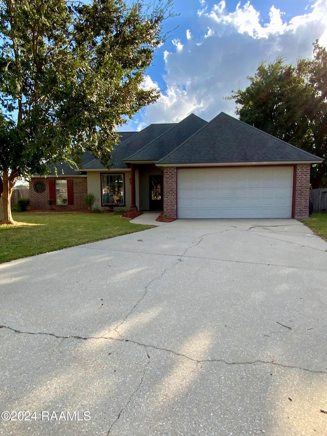 ranch-style house with a front yard and a garage