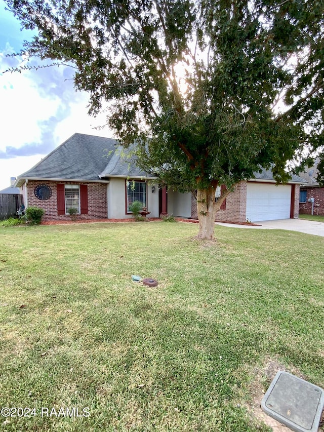 view of front of home with a front lawn and a garage