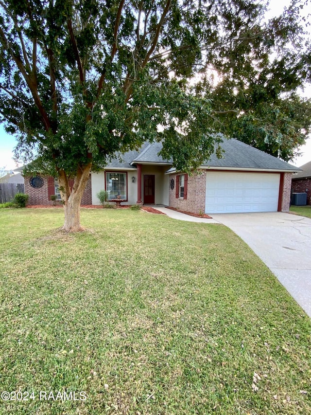 single story home featuring a front lawn and a garage