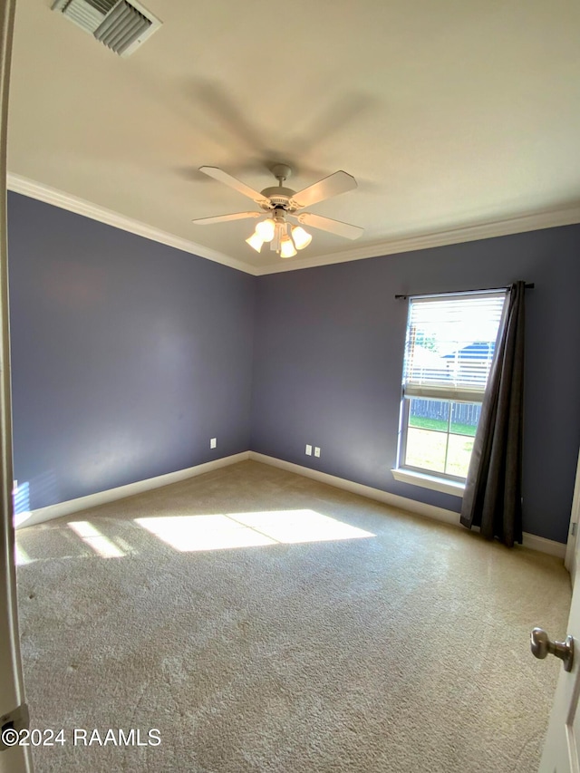 carpeted empty room with ornamental molding and ceiling fan