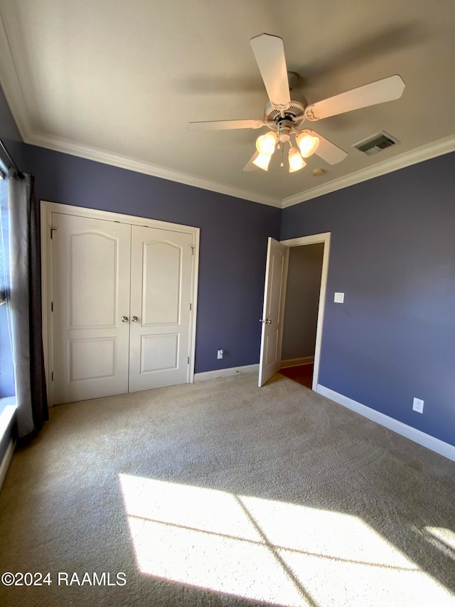 unfurnished bedroom with crown molding, carpet, and ceiling fan