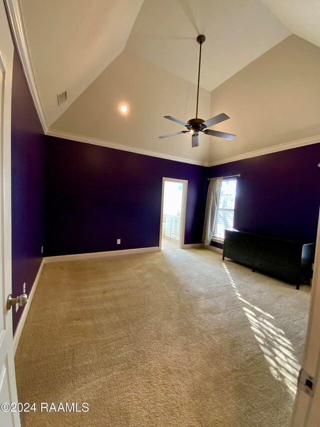 unfurnished bedroom with ornamental molding, vaulted ceiling, and carpet floors