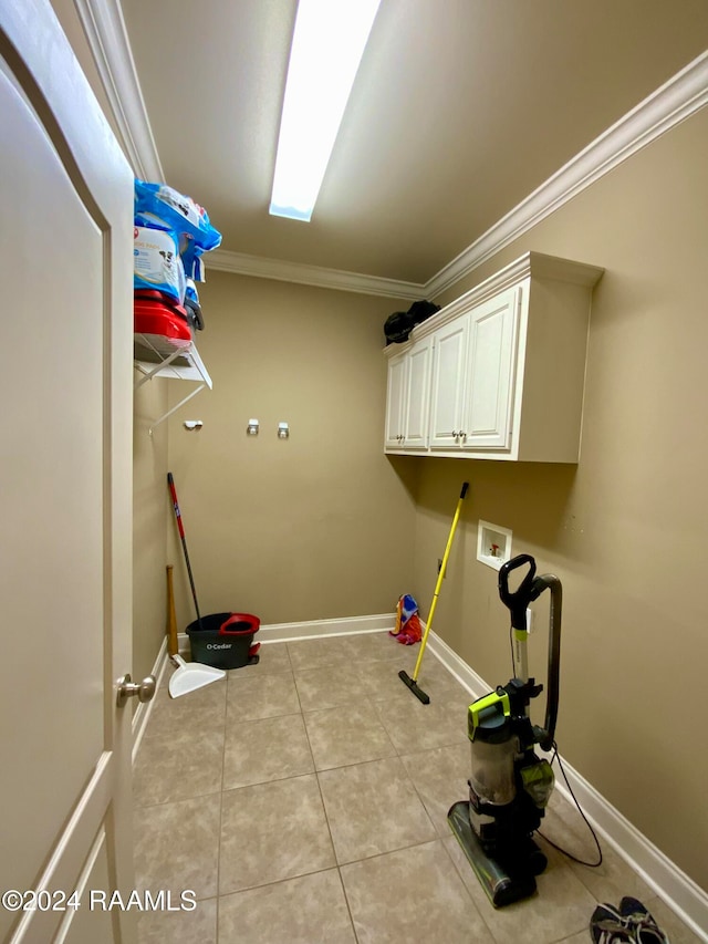 laundry room featuring cabinets, ornamental molding, light tile patterned flooring, and washer hookup