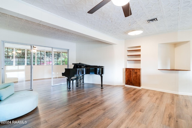 miscellaneous room with wood-type flooring and ceiling fan