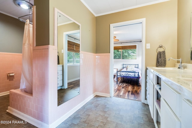 bathroom featuring tile walls, vanity, hardwood / wood-style floors, and ornamental molding