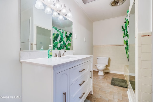 bathroom with tile walls, vanity, a shower with curtain, and toilet