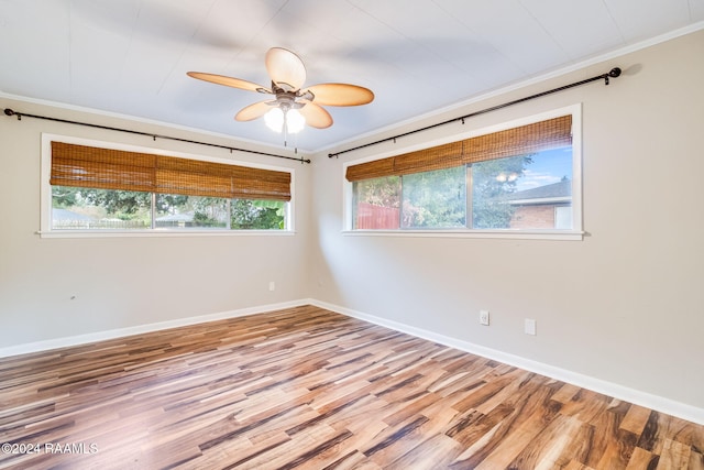 spare room featuring crown molding, light hardwood / wood-style floors, and ceiling fan