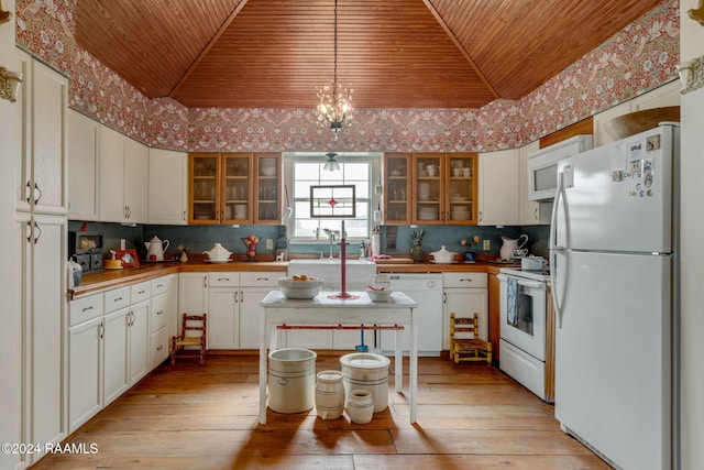 kitchen with white cabinetry, white appliances, decorative light fixtures, and light wood-type flooring