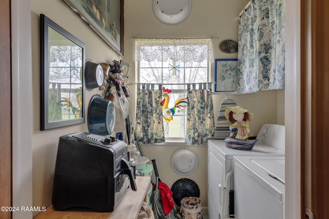 clothes washing area featuring a wealth of natural light and separate washer and dryer