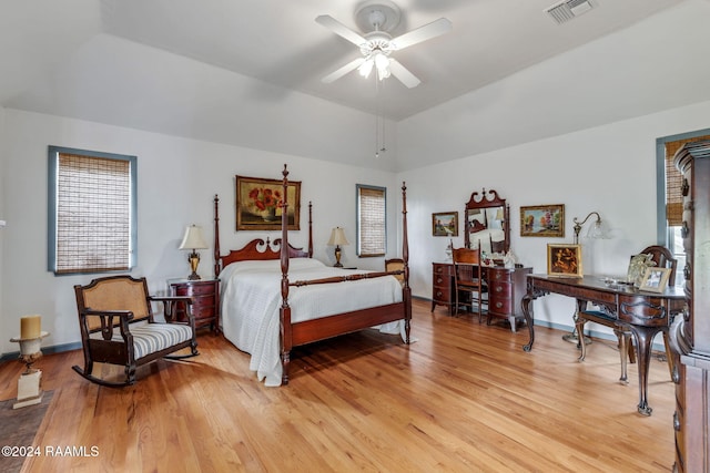 bedroom with light hardwood / wood-style floors, ceiling fan, and multiple windows